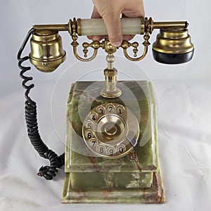 Image of an old telephone from before the 1960s on white background