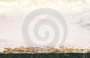 Image of old wooden table in front of glitter lights background. De-focused. Ready for product display montage.