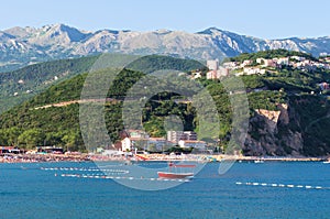 Image of one red boat against Jaz beach