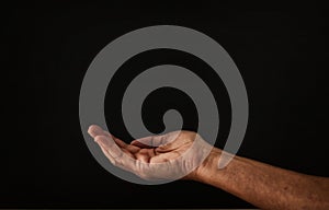 image of open male hand begging for help.