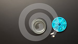 open pillbox with some pills