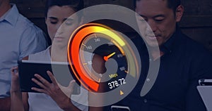 Image of orange speedometer over diverse businesspeople with electronic devices