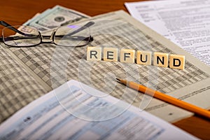 Image ot tax refund with forms, pencil, glasses and money