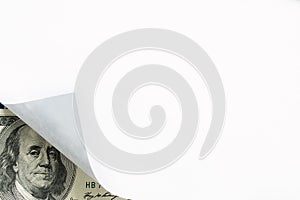 An image of paper curl and hundred dollar bill