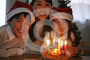 Parent and child blowing out a candle