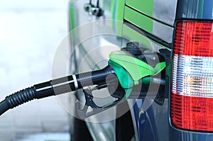 Image of a part of a car at a gas station