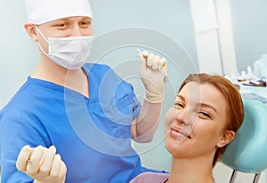 Image of patient sitting on dental armchair with doctor