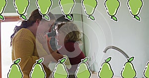 Image of pear icons over caucasian woman with son in kitchen photo