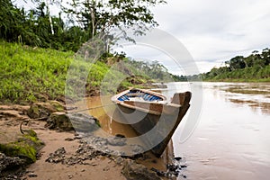 Image in Peruvian jungle of a boat in a river in Amazon forest. Traditional way of transportation in tropical rivers