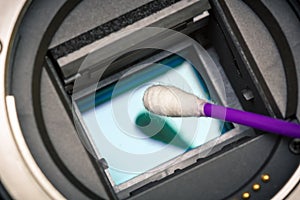 Image photo sensor being cleaned with a cue tip.