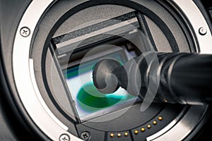 Image photo sensor being cleaned with a lens pen.