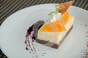 Image of a piece cheese cake with mandarins