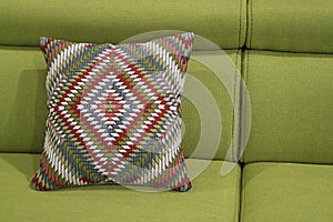 An image of a pillow lying on the couch