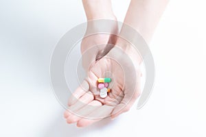 Image of pills on a female palm. The concept of medicine, health care, vitamins