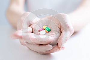 Image of pills on a female palm. The concept of medicine, health care, vitamins