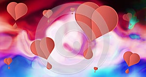 Image of pink hearts moving on multi coloured background