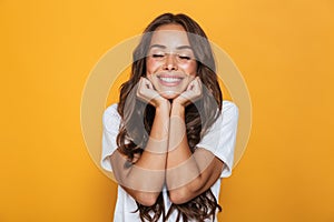 Image of positive young woman 20s with long hair laughing and pr