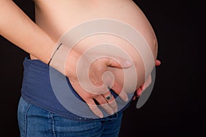 Image of pregnant woman touching her belly