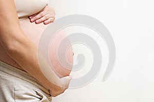 Image of pregnant woman touching her big belly. Motherhood, pregnancy, people and expectation concept. Pregnant woman expecting