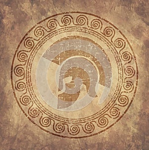 Spartan helmet an icon on old paper in style grunge, is issued in antique Greek style. photo