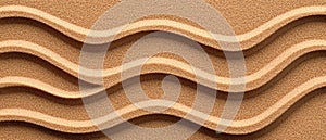 A textured image of sand with a repeating wave pattern.