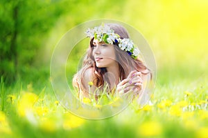 Image of pretty woman lying down on dandelions field, happy che