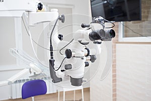 Image of a professional dental endodontic binocular microscope with a camera in the treatment room