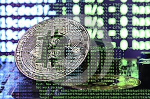 Image of the program code showing the process of mining the crypto currency in the background of the image with bitcoin