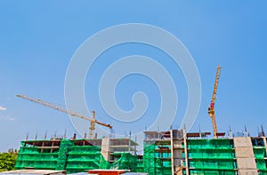 image of property construction site with cranes and clear blue