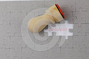 Image of Puzzle piece with solution and Official seal
