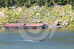 Image of raft floating on the water and long tail boat