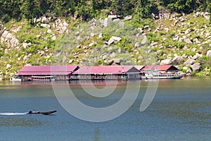 Image of raft floating on the water and long tail boat