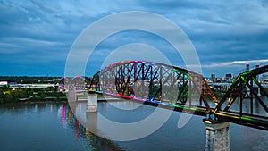 Rainbow pride illuminated bridge at night aerial over Ohio River Kentucky