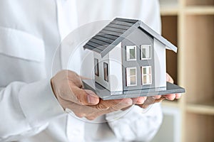 Image of Real estate broker agent sending house model to client after approve, home model mortgage loan offer for and house