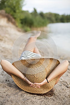 Image of relaxing female in big hat