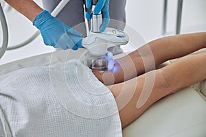 Image of Rf skin tightening on woman legs in beauty clinic