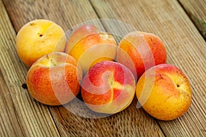 Image of ripe juicy apricots on wooden table in kitchen