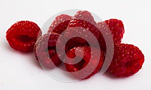 Image of ripe red fresh raspberries on white surface