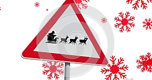 Image of road sign with black silhouette of santa claus in sleigh being pulled by reindeer