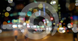 Image of road traffic in city at night with blurred city lights and colourful spots of light in the 