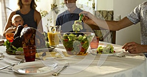 Image of roasted turkey on holiday table and family on background