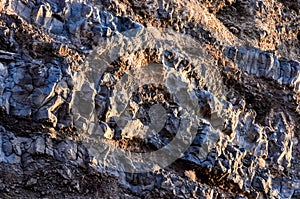 The image is of a rocky cliff with a blue and gray color scheme