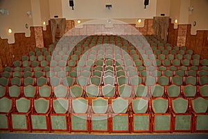 rows of green chairs in a theater auditorium