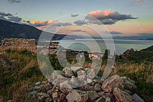 Ruins of a medieval castle in Astros at sunset on the Peloponnese in Greece photo