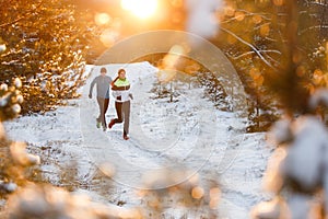 Image of running sports women and men in winter park