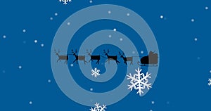 Image of santa claus in sleigh with reindeer over snow falling on blue background