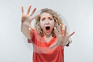 Image of scared blonde girl. Fright, phobia and facial expression concept. Studio shot, white background, isolated