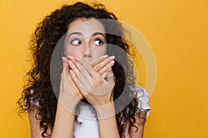 Image of scared or shocked woman 20s with curly hair smiling and