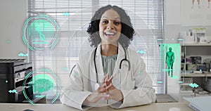 Image of science icons and data processing over biracial female doctor having image call