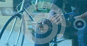 Image of scopes scanning and data processing on screens over man using smartphone